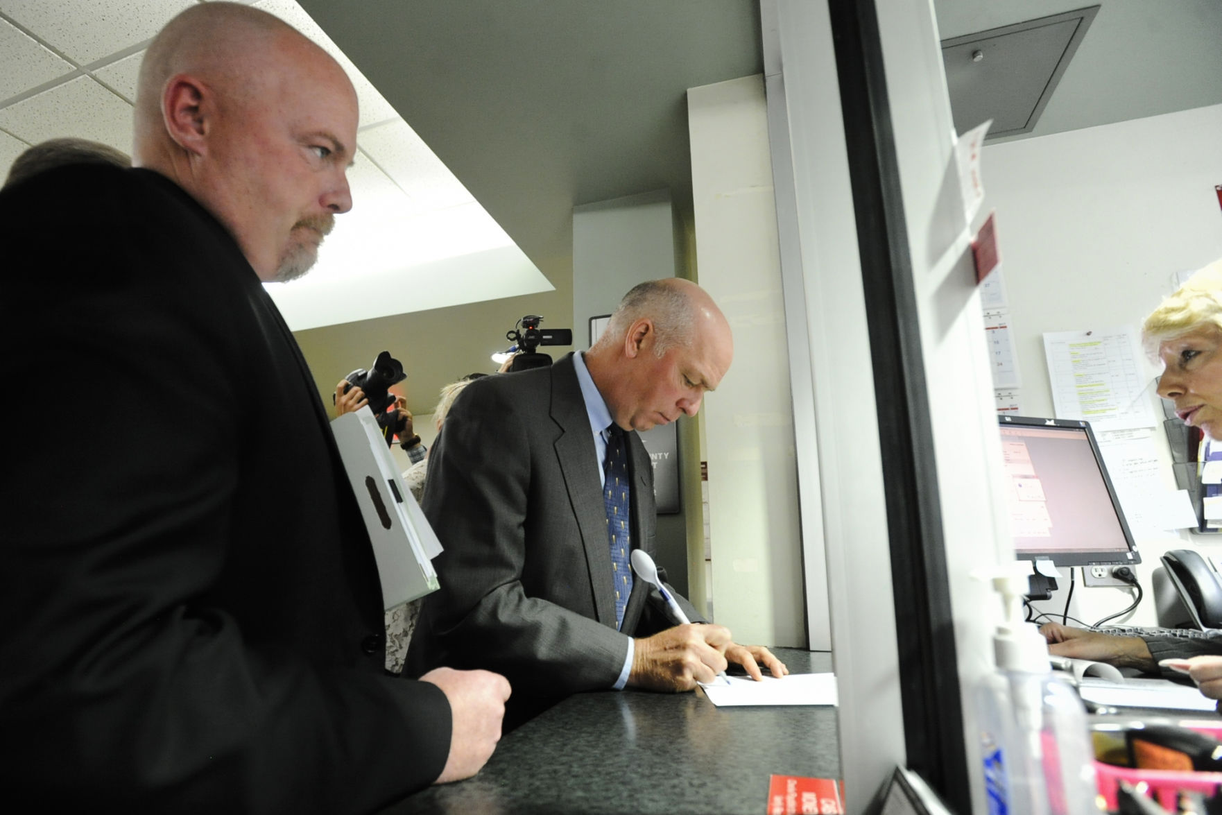 Republican congressman-elect Greg Gianforte signs paperwork Monday morning